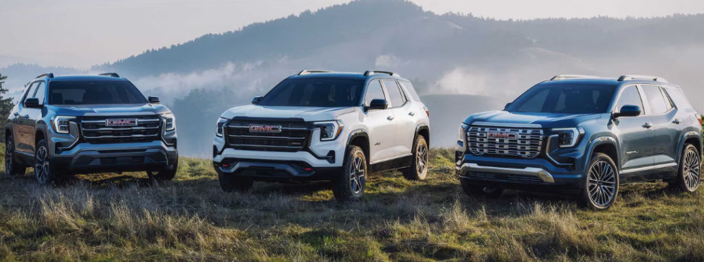 Three 2025 GMC Terrain models parked in a field